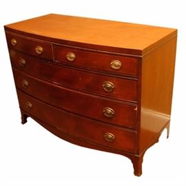 Wooden Dresser: A wooden dresser. This wooden dresser features five drawers with brass Heppelwhite pulls and square legs. The piece is unmarked. For a coordinating piece see 17NAS023-090
