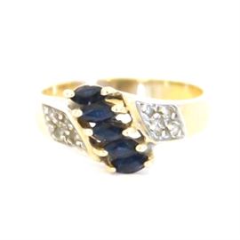 10K Yellow Gold Ring With Diamonds and Blue Sapphire: A 10K yellow gold ring with diamonds and blue sapphires.
