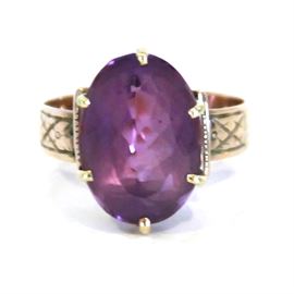 Gold tone and Purple Stone Ring: A gold and purple stone ring.