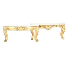 Pair Of Antique Marble and Gilt Gold Shelves: A pair of antique marble and gilt gold shelves. These rectangular pieces feature wooden bases which have filigree details, cabriole style legs, and are finished in a bright gold color. They have white marble tops with beveled edges.