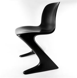 Modern "Z" Chair: A modern style “Z” chair. This unique, modern chair gets its name from its resemblance to the letter “Z.” The chair is made of composite wood that has been coated in a black lacquer.
