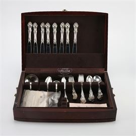 1940 Sterling Silver Westmorland Flatware Set in Box: A 1940 sterling Westmorland forty-four piece silverware set in box. This set has eight dinner knives, eight dinner forks, eight salad forks, eight teaspoons, eight soup spoons, a ladle, a serving spoon, a butter knife, and an ice cream spoon. All pieces come in a dark finished wood storage box lined with silver cloth and with included polishing cloth. Also included is a booklet titled “Your Sterling and You.” Total approximate weight excluding dinner knives is 44.67 ozt.