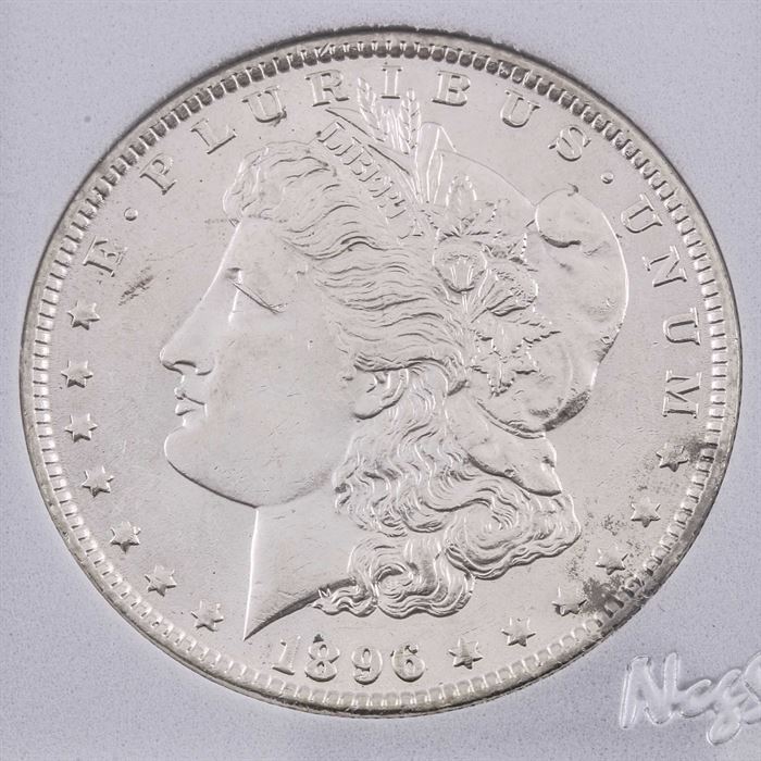 1896 Silver Morgan Dollar: An 1896 silver Morgan dollar. Designer: George T. Morgan. Mintage: 9,976,000. Metal content: 90% silver, 10% copper. Diameter: 38.1 mm. Weight: 26.7 grams. Very good condition.