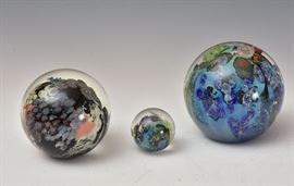 Two Josh Simpson Art Glass Paperweights
including 4" high Mega Planet together with a
Josh Simpson marble
all signed