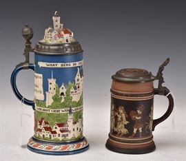 Two Mettlach Beer Steins	
Town of Wartburg, #2828, 1 liter, 12" high
together with Villeroy & Boch Mettlach
Character Stein, #9302, 1/2 liter,
8" high (to top of handle)