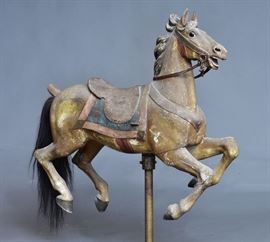 American Carved Carousel Horse	
attributed to Gustav Dentzel
43" long, 51" high, including the stand
early 20th century