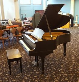 Steinway Grand Piano	
Model M
no serial number visible
with bench
2nd quarter 20th century
CONDITION REPORT: Original action. Replaced tuning pins, vampors, strings, keys. Two cracks in the sound board. Refinished with scuffs to top and veneer chip on front edge. Bench with detached top.