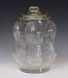 Planters Peanuts Display Glass Jar	
with four molded peanut corners and
embossed "Planters" on four sides
13 1/2" high
marked "Made in USA"
circa 1930