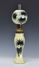 Handel Ware Kerosene Lamp	
palm leaf decoration on a yellow ground
6" diameter shade
20 1/4" high overall (excluding chimney)
molded base stamped, #223/1043
signed P.J. Handel, Meriden, CT