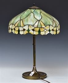 Leaded Glass Table Lamp	
green slag glass with a flower border
16" diameter shade, 23" high
early 20th century