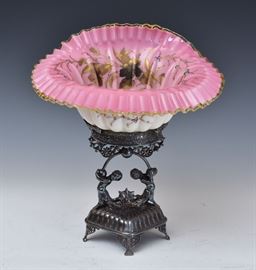 Victorian Bride's Basket	
pink with floral paint decoration
signed Meriden, B. Company
on a figural silver plated stand
14 1/2" high
early 20th century