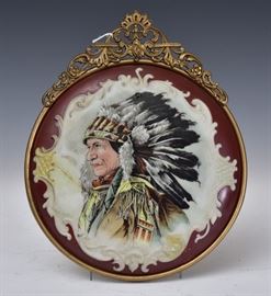 Wave Crest Plaque	
with a portrait of a Native American
and scroll molded background
9 1/2" diameter
in a gilt metal frame
circa 1900