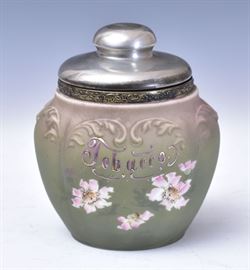 Wave Crest Jardiniere	
scroll molded with pink flowers on a 
green ground, the gilt metal base with cherubs
8" high
early 20th centuryWave Crest Tobacco Jar	
scroll molded with pink flowers on a 
green ground, embossed "Tobacco"
with silver plated collar and lid
7 1/2" high overall
early 20th century
