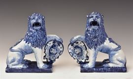 Pair of Dutch Delft Blue and White Lions	
each tin glazed, seated with open mouth and
one paw supporting a heraldic shield
9" high
19th century