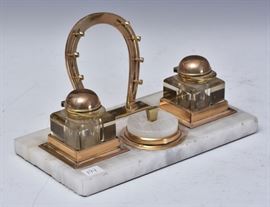 Horse Racing Standish	
two inkwells with jockey hat lids
brass and onyx, 10 1/2" long
early 20th century