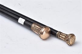 Two Victorian 14k Gold Tipped Canes
heavily embossed
32 1/2" and 36" long
one inscribed "Xmas '90"