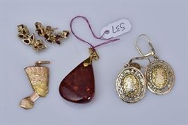 Group of Jewelry
including amber pendant, garnet earrings,
Egyptian head pendant and a pair
of 14k gold drop earrings