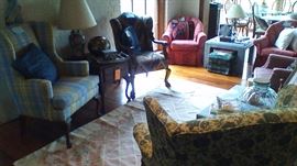 Three wing back chairs, and a pair of matching barrel back chairs.