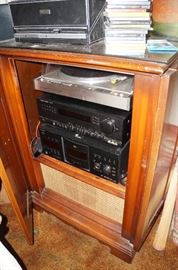 Old radio cabinet and some modern day stereo components.