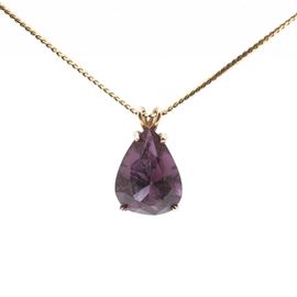 14K Yellow Gold Sapphire Pendant and 18K Yellow Gold Chain: A 14K yellow gold sapphire pendant and 18K yellow gold chain. This item features a faceted pear-shaped sapphire that changes color from purple to red.