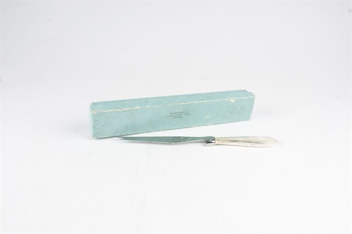 Tiffany & Co Cheese Knife: A Tiffany & Co cheese knife. This knife has a sterling silver handle and a stainless steel blade. The total approximate weight, exclusive of non-sterling, is 1.54 ozt.