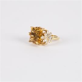 18K Gold Square Citrine and Diamond Cocktail Ring: An 18K gold square citrine and diamond cocktail ring. The ring features a square cut citrine stone with diamonds in floral settings to each side.