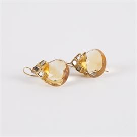 18K Gold Pear Shape Citrine and Diamond Earrings: An 18K gold pear shape citrine and diamond earrings.
