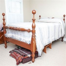 Mahogany Full Bed Frame: A mahogany full bed frame. This frame has cannonball posts along the head and foot boards with wooden side rails. The four legs rest upon bun feet. Please note that the bedding pictured is not included.