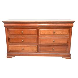 Contemporary French Pine Double Dresser: A Contemporary French pine double dresser. This piece has a rectangular top and a six-drawer front with top-shaped knobs along the fronts. Inside the top drawer is a sticker for the French furniture safety certification association. This piece sits upon four bracket feet.