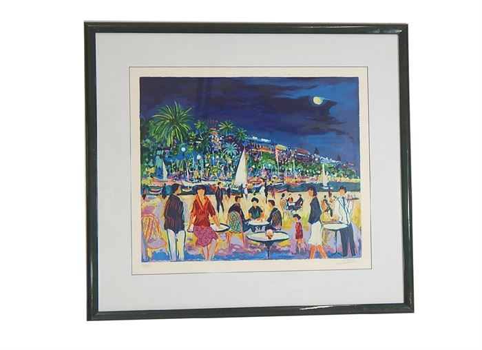 Jean-Claude Picot Signed Seriolithograph: A limited edition seriolithograph print on archival paper by internationally renowned and well-listed artist Jean Claude Picot (France, b. 1933). The print depicts a view of a coastal landscape, with a bustling gathering with bistro tables and mingling people to one side of the waterway, and a high-energy nightlife scene with palm trees and well lit colorful buildings to the other side of the waterway. The fun atmosphere takes place under a moonlit sky. This print is number 70 in an edition of 350. The print is signed in pencil to the lower right and numbered in pencil to the lower left. Presented behind glass with white matting and black frame.