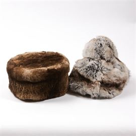 Pair of Fur Hats: A pair of fur hats. Featuring two brown and gray animal fur hats. The gray hat is marked “Muriel Hat New York” and has a silky black lining. The brown sheared fur hat has a fabric lining and is unmarked.