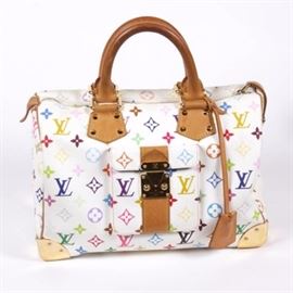 Louis Vuitton Multicolore Speedy 30 Handbag: A Louis Vuitton Multicolore Speedy 30 handbag. This 2004 bag features colorful monogram print coated canvas construction with vachetta leather accents and gold tone hardware. The interior of the handbag is lined in soft red microfiber. A leather tab to one corner is stamped, “Louis Vuitton Paris Made in France” and the date code, SP0024, is stamped into the lining. A cloth storage bag is included.