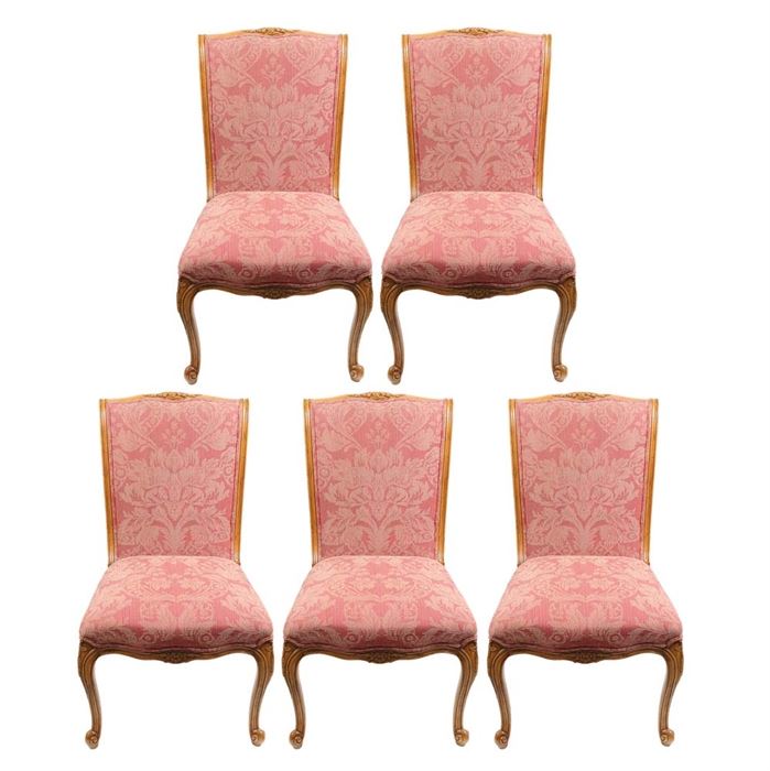 EJ Victor Louis XV Dining Chairs: A set of five EJ Victor upholstered Louis XV dining chairs. The chairs have a light oak wood frame with a floral carvings to the rails and skirts. Each chair is upholstered with a light red upholstery and rests on four cabriole legs.