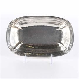 International Sterling Small Tray: An International Sterling sterling silver small tray. The tray features a hammered design with a scroll, plume and reeded edge. The piece is marked “International Sterling D187” to underside. The total weight is approximately 9.250 ozt.