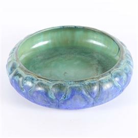 Fulper Pottery Two-Tone Bowl: A Fulper Pottery hand thrown two-tone bowl. The shallow bowl has a wide opening and is finished with a blue glaze to the exterior and a light green glaze to the interior. The bottom of the piece is stamped, “FULPER”.