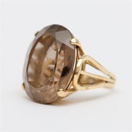 18K Gold Smoky Quartz Ring: An 18K yellow gold cocktail ring with a prong set oval smoky quartz.
