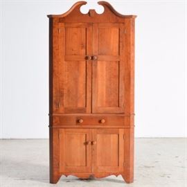 Vintage Pie Safe in Cherry: A cherry pie safe with two upper cabinet doors and pierced tin panels on the side. The top doors are solid and open to two removable shelves. Below is a full length drawer with two round knobs with machine cut dove tail construction. The lower cabinet has two doors and one knob, with one shelf inside. The piece stands on four straight legs.