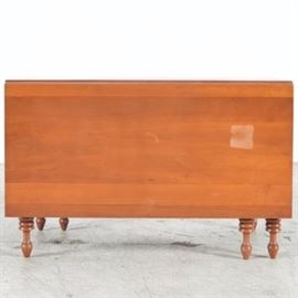Cherry Drop Leaf Table: A cherry drop leaf table. This table is a rectangular design. Each drop leaf is twenty-two inches wide and is set on six turned legs with turnip feet.