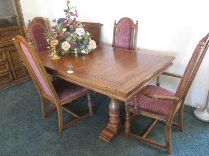 Traditional Dining Room Group.  Trestle legs and a plank wood table top. Included are 6 chairs and 2 table leaves.