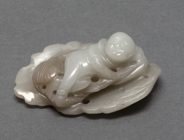 Chinese jade carving of a boy lying on a leaf, Qing dynasty, 2.56in(L) x 1.57in(W)