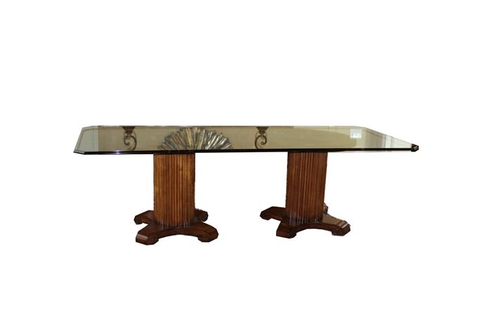 Glass-Top Dining Table With Double Pedestal Base: A glass-top dining table with a double wooden pedestal base. This stunning designer table features a custom glass top with a gentle ogee edge and angled corners. It is raised on two Century Furniture solid wood bases with carved concentric ring detail to the top, reeded and fluted posts, and low legs with spiral feet.

Founded in 1947, Century Furniture provides finely crafted luxury furniture. It is a third-generation family-owned company located in Hickory, North Carolina.

• Companion chairs can be found in listings 17CIN182-003 and -004.