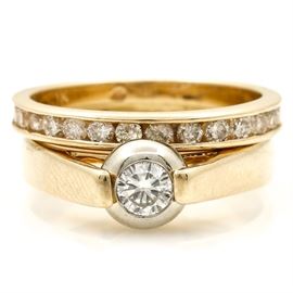 Yellow Gold Wedding Set: A yellow gold wedding set. This features a wedding band and an engagement ring soldered together. The band is 10K and the engagement ring is 14K. They both have these specific hallmarks to the interior of the ring. The total approximate carat weight of all diamonds included is 0.77 ctw.