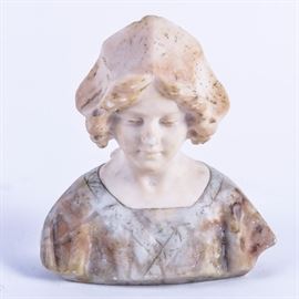 Studio of Sarchez Alabaster Bust: An alabaster bust from the studio of Sarchez. The bust depicts a woman wearing a bonnet gazing downward and dressed in a gown with faint floral detailing. The piece is marked in the lower back “Prof. Sanchez” and “Made in Italy”.