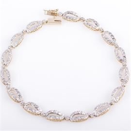 14K Yellow Gold and Diamond Open Oval Link Bracelet: A 14K yellow gold bracelet featuring diamond encrusted open oval shaped links mounted in a filigree setting.