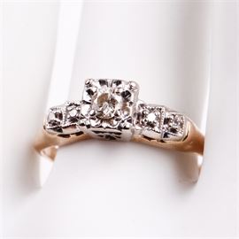 14K Two-Tone Gold and Diamond Engagement Ring: A 14K yellow gold ring featuring round cut diamonds mounted in 14K white gold surface prong settings with mil grain edges and an open under gallery.