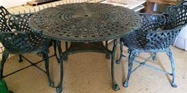 Wrought Iron Umbrella Table w/4 Chairs (Two not pictured)