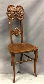 Antique 19th Century Tiger oak hall chair, ornately carved w/ "North Wind" face, tag marked "Lammert Furniture Co, St. Louis", 40" tall x 15.25" wide x 17" deep
