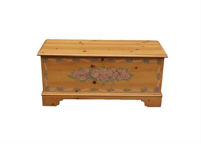 Lane Furniture Cedar Chest: A Lane Furniture cedar chest. This cedar chest is made of light-toned cedar. It has a floral motif on the front side and is made using “Aroma-Tite” construction. It is marked to the interior. The chest locks and includes the key