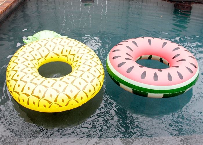 Pair of Bigmouth Inflatable Pool Floats: A pair of Bigmouth inflatable pool floats. These pool floats depict a large watermelon slice as well as a pineapple. Each is made of heavy duty plastic and is inflatable. They are marked “Bigmouth” to the reverse.