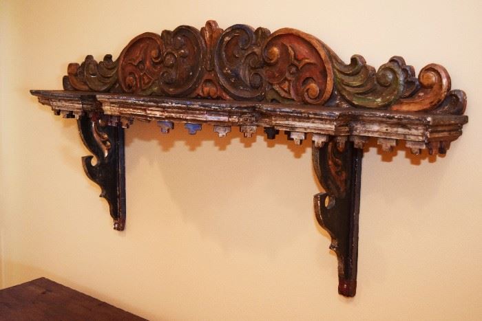 Colonial  Spanish  polychrome  bracket  shelf,  likely  an  alterpiece  
Fragment,  fully  painted  and  carved  with  ‘C’  scrolls,  scrollwork  and  Hanging  dentil  pattern  pendants.  